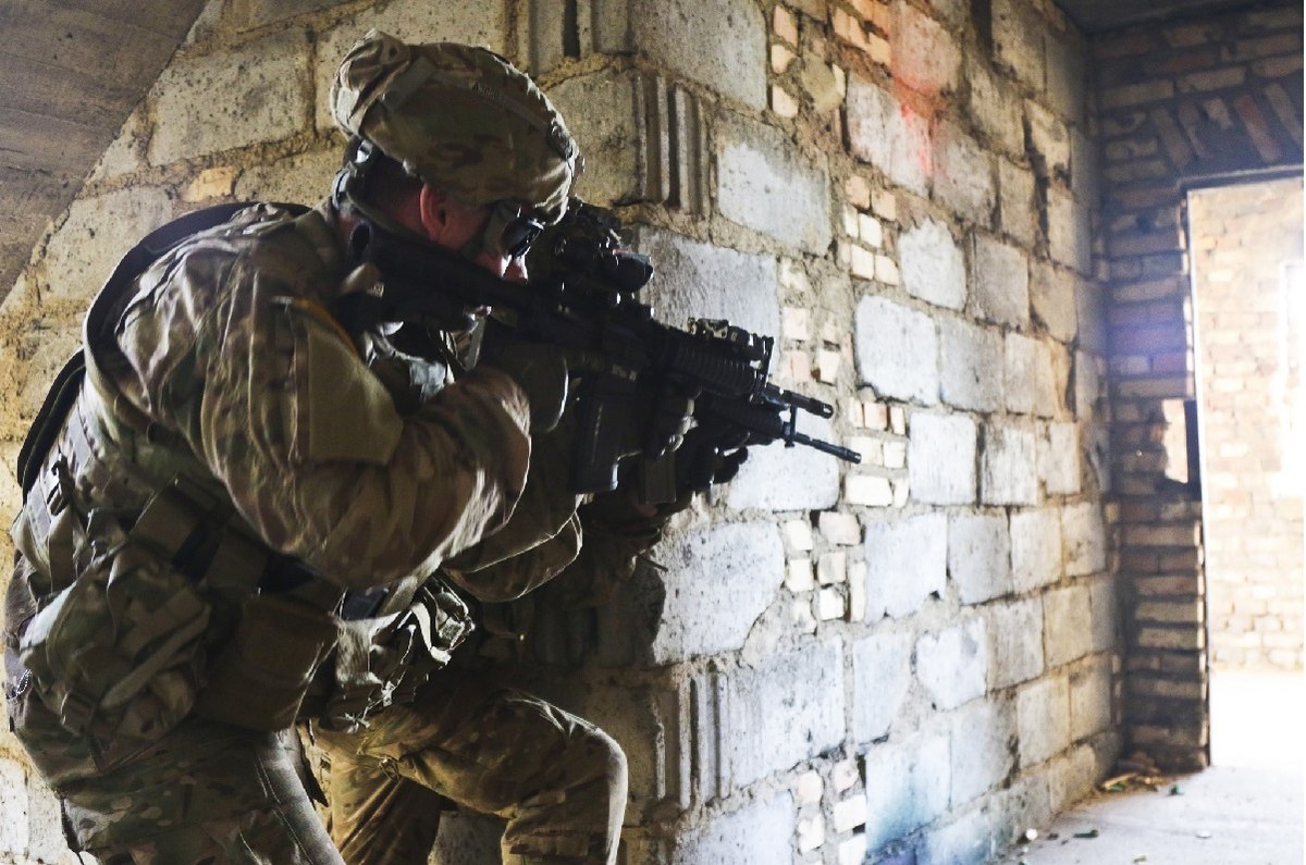 Paratroopers clear the floor of a building during training. As the multi-domain fight evolves and soldiers are deployed in smaller units and to remote locations, Army medicine must adapt to use new technologies, the Army's surgeon general says. (Sgt. William A. Tanner/Army)