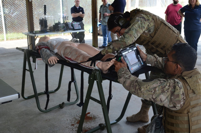 Field medics perform a simulated escharotomy using the Remote Diagnostic Technologies i2i Solution (Tempus Pro) at TATRC, Fort Detrick, 7 September.