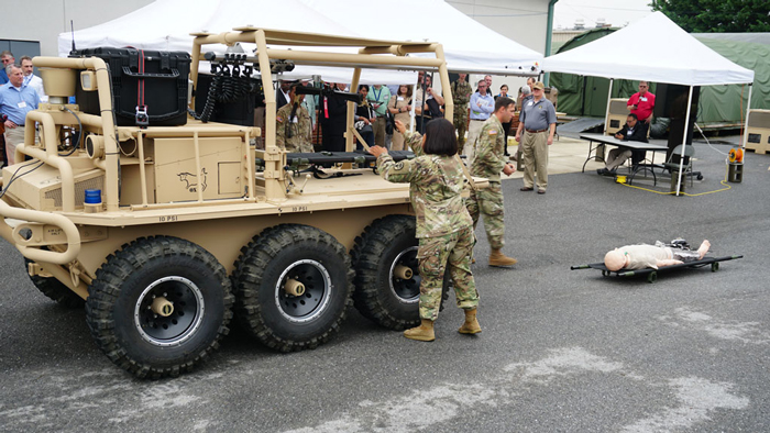 Soldiers demonstrate loading a casualty onto the unmanned Squad Multi-Purpose Equipment Transport (SMET). 