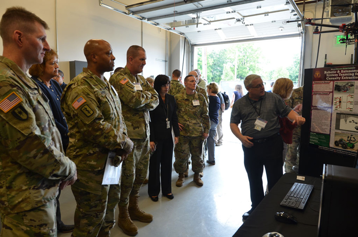 BG Shan Bagby, Deputy Chief of Staff for Support, MEDCOM G-1/4/6 (3rd from left) gets briefed on autonomous casualty evacuation.