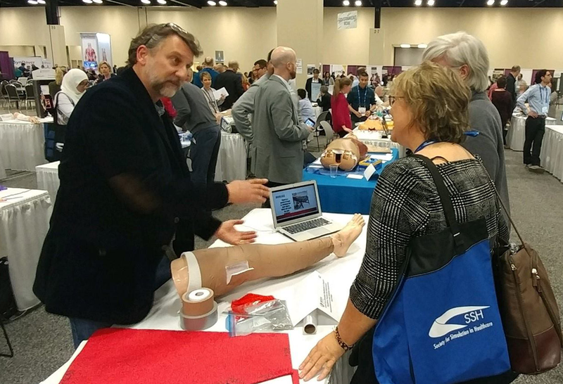 MMSIV Lab Lead, Mr. Geoff Miller, demonstrates a simulated escharotomy prodecure to conference attendees