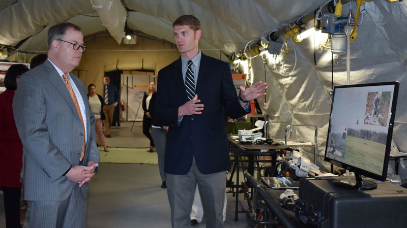Mr. Nate Fisher (MISL) briefing the Hon. Mr. McCaffery, ASD-HA, on key concepts of MRAS.