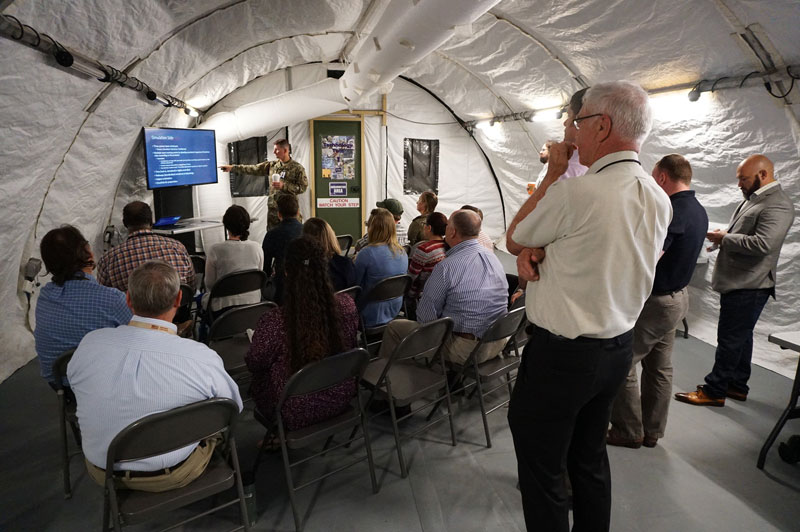 TATRC Director, COL Jeremy Pamplin, briefs staff and attendees on the value of TelePFC.