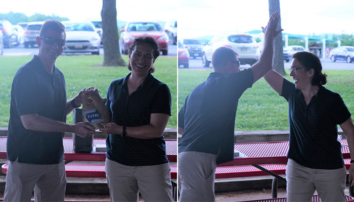 Outgoing Director, COL Gina Adam, presents incoming Director, COL Jeremy Pamplin, with the “Innovation Gauntlet,” followed by celebratory High-Fives!