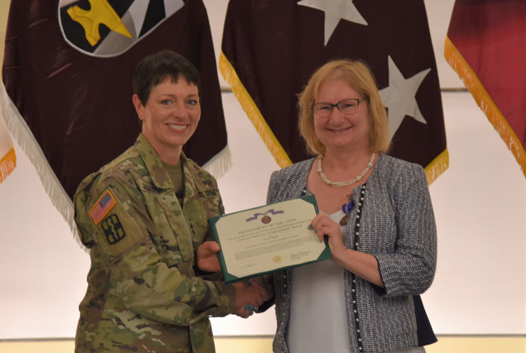 Ms. Merritt receiving an award from MG Holcomb.