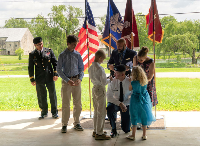 COL Pamplin’s family pins the Eagles onto his shoulder boards.