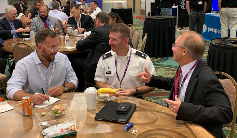 COL Jeremy Pamplin (center) catches up with TATRC’s former-Director COL(R) Dan Kral (left) and Dr. Bob Walker from DHA (right).