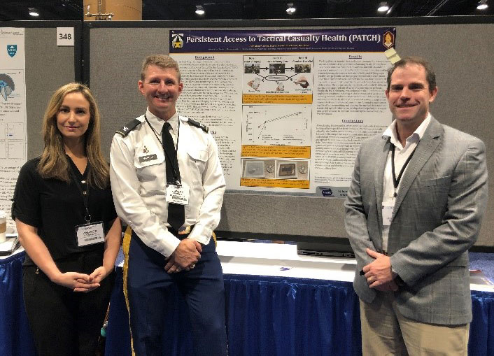Ms. Amanda Schmeltz, COL Jeremy Pamplin, & Mr. Ron Yeaw representing one of the many TATRC posters during the scientific poster session.