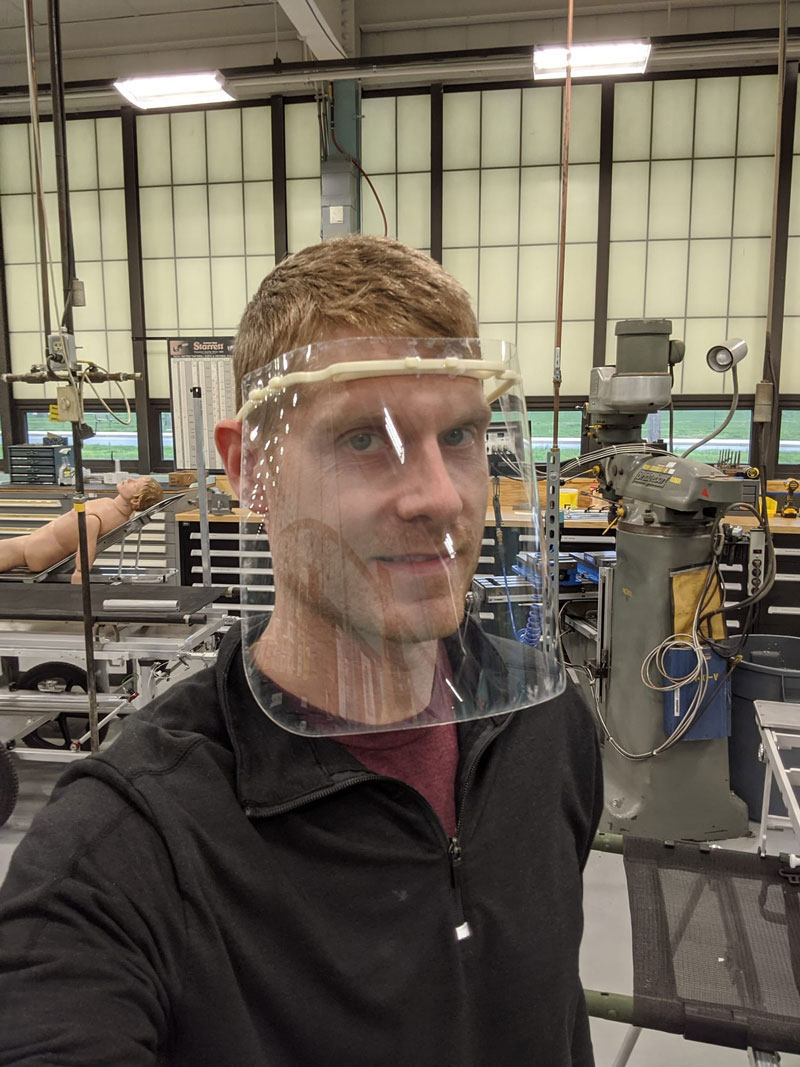 Mr. Nate Fisher demoing a sample protype of a face shield produced in-house.