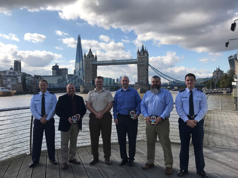 Group Photo from the HMS President on the Thames River with the Tower Bridge in the background. Personnel from left to right are: 2LT Matt Dickinson, Mr. James Beach, Lt Col Bartels, Dr. Gregory Burnett, Mr. Jeff Luciano, and 2LT Corey Mack.