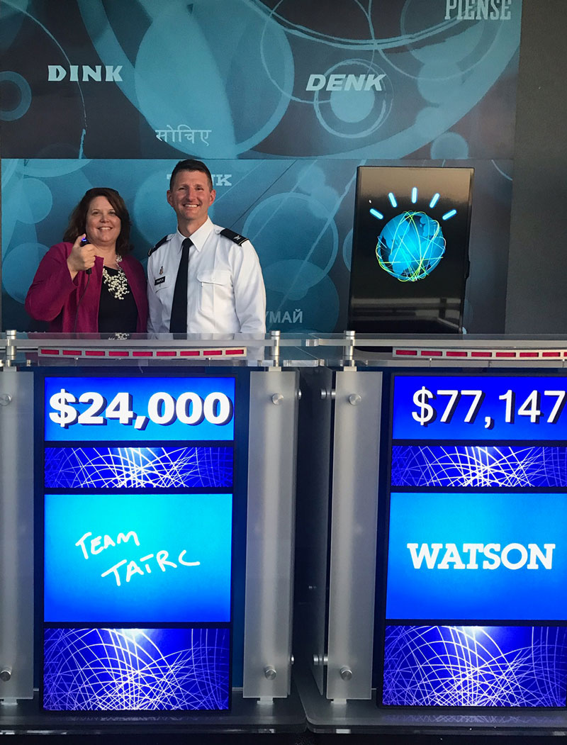 During their visit, Ms. Jeanette Little (left) and COL Jeremy Pamplin (right) teamed up against IBM Watson in a friendly game of ‘Jeopardy!’.