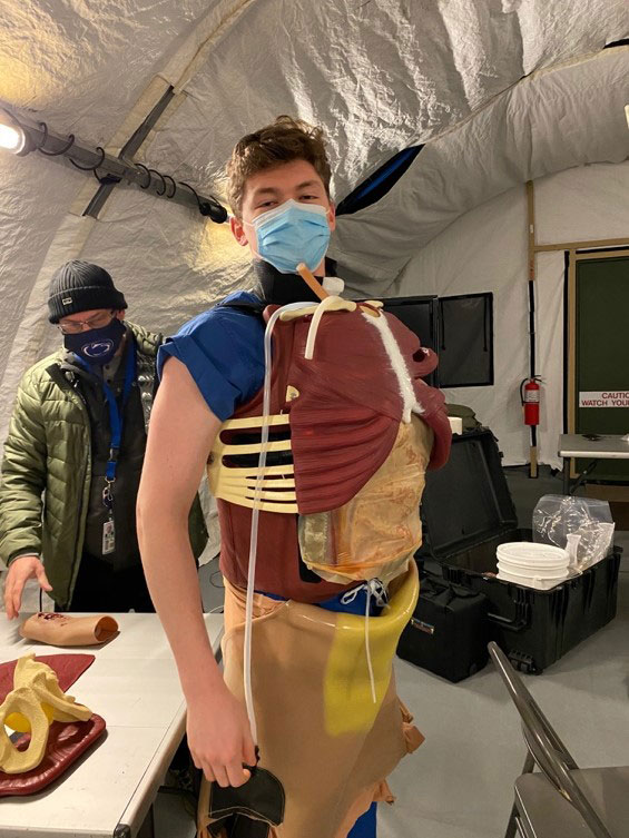 Mr. Zach Buono wearing the Surgical CutSuit vest as MMSIV’s Rob Shotto assists in the background. 