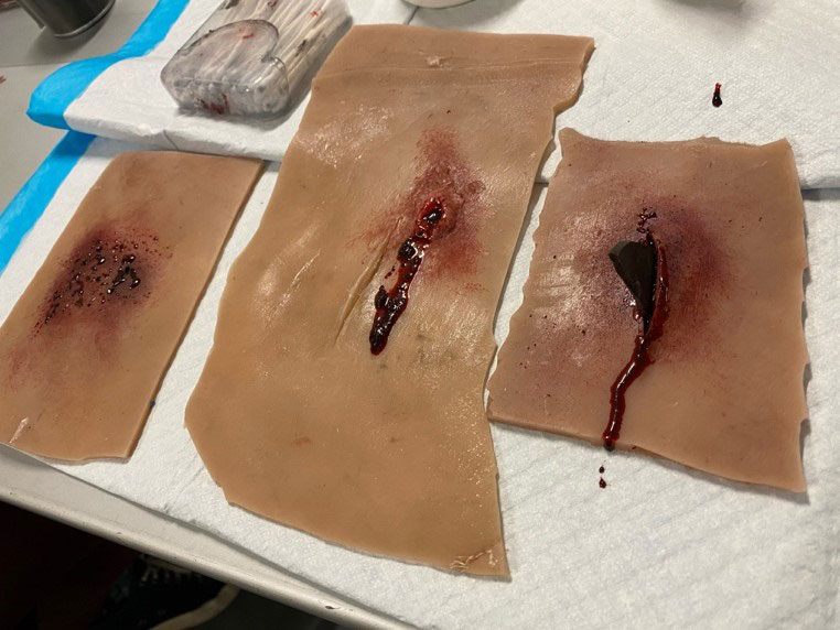 Various simulated wounds created on synthetic skin during moulage training.