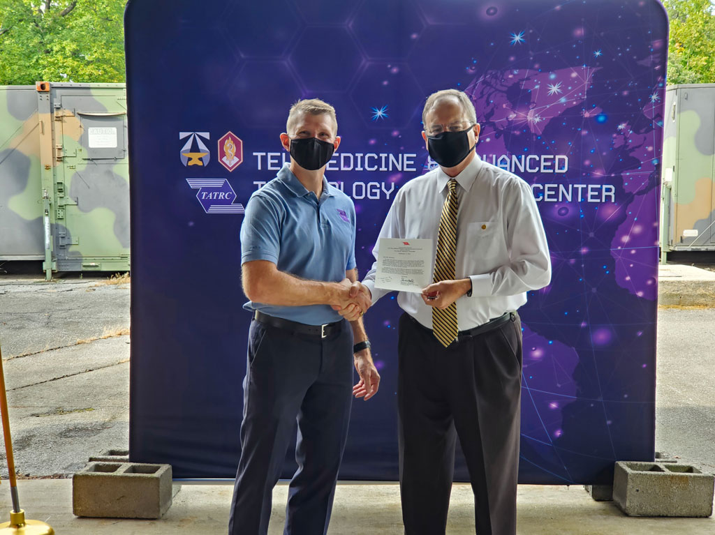 COL Jeremy C. Pamplin (left) presented numerous awards and certificates to Mr. Greg Dempsey (right) for his 15 years of outstanding service with TATRC.