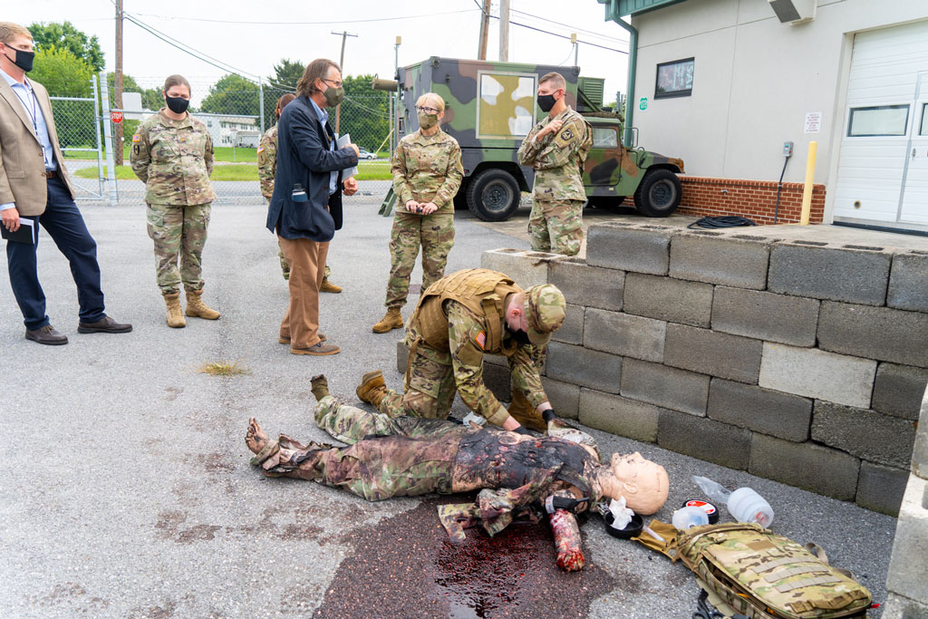 Mr. Geoff Miller, MMSIV Division Chief, walks BG Simonson through a simulated, casualty scenario, as demonstrated by TATRC's MMSIV team. 