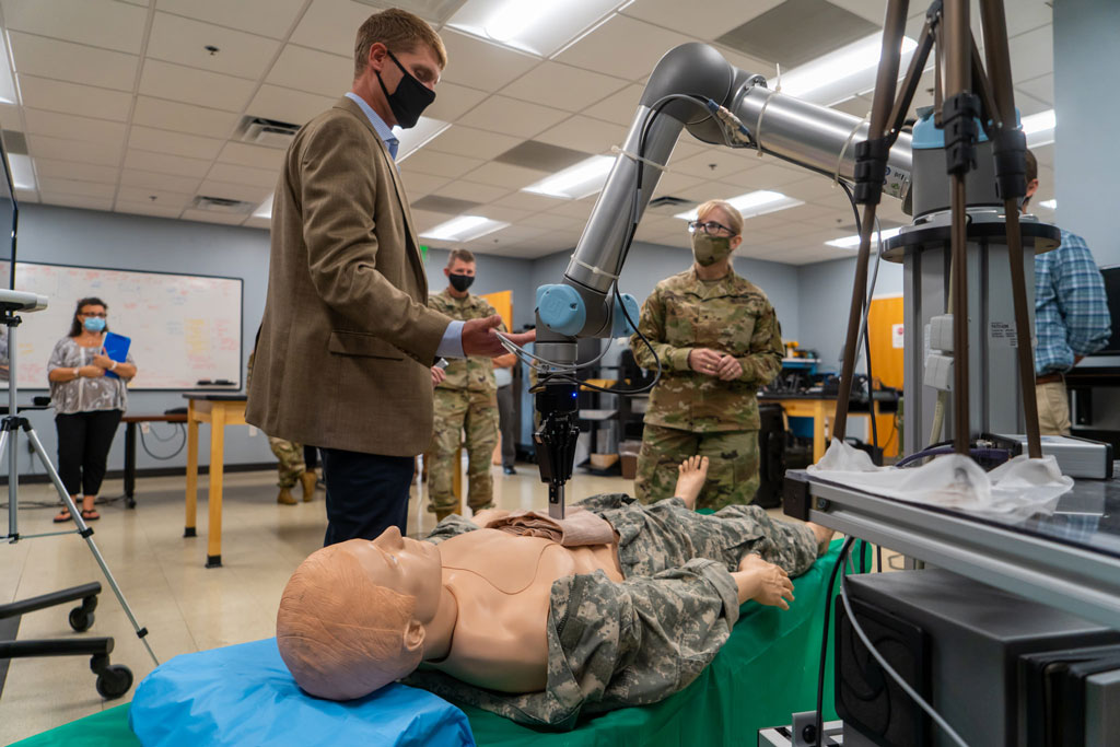 Mr. Nate Fisher, MedRAS Division Chief, shows BG Simonson some of the research initiatives in autonomous systems and robotics.