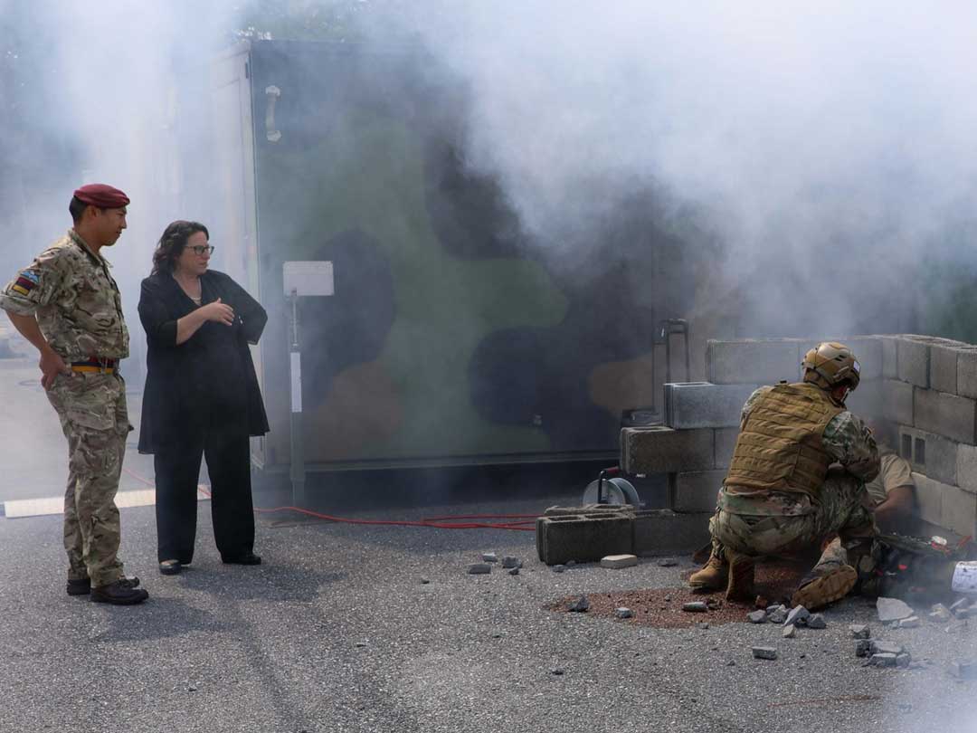 Photo of Maj Pang with MMSIV Functional Area Lead watching a medic in simulation exercise